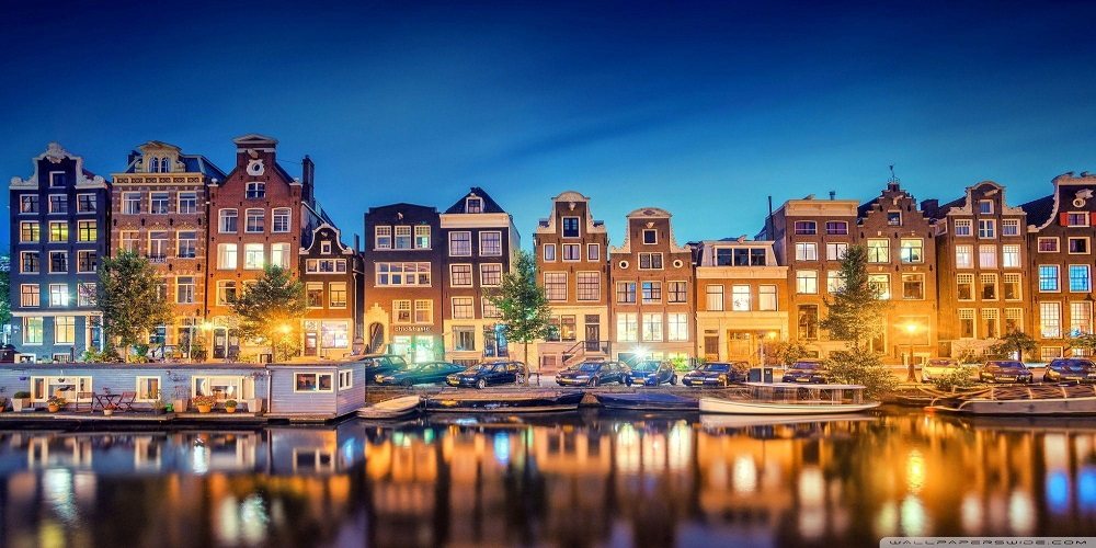 Europe — canal houses lit at night