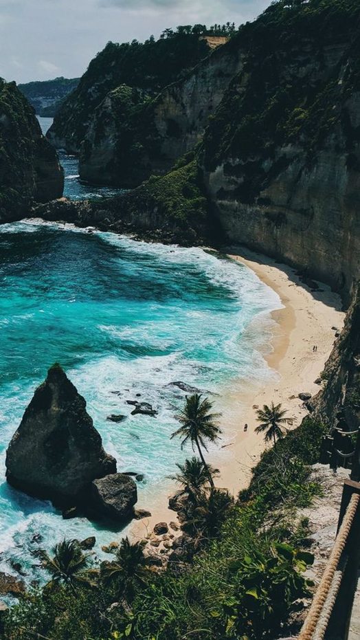 A bay of limestone cliffs and green water seen from above