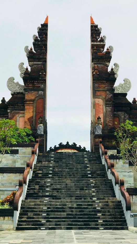 A stone stairway between the two halves of a carved temple gate
