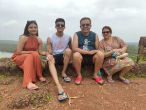Four guests photographed on a cliff path above the sea