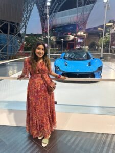 A guest photographed beside a sports car