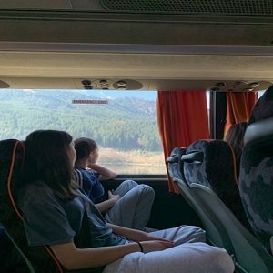 Students on a coach looking out at the hillsides
